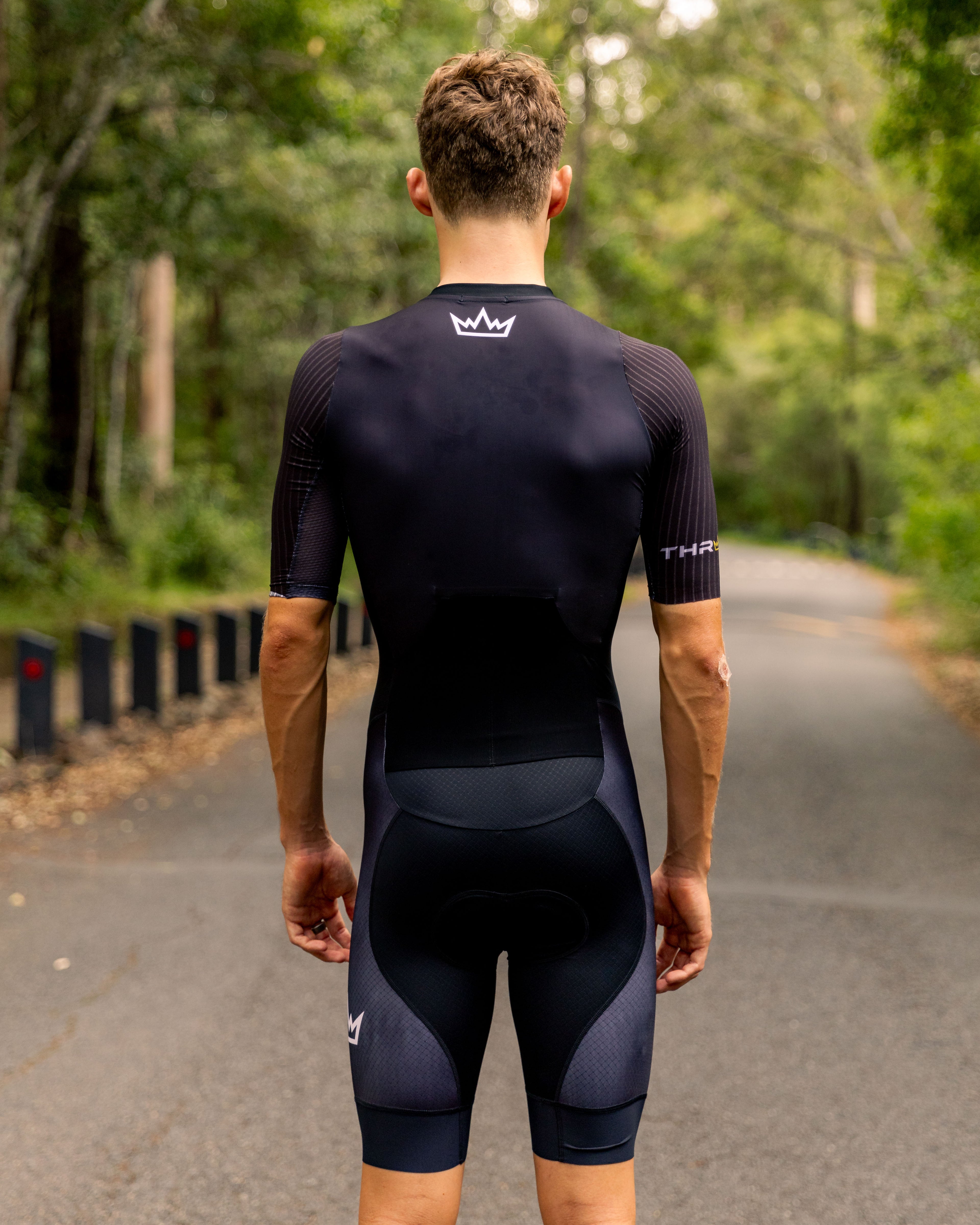 Man wearing THRONE VALOR black short-sleeve trisuit