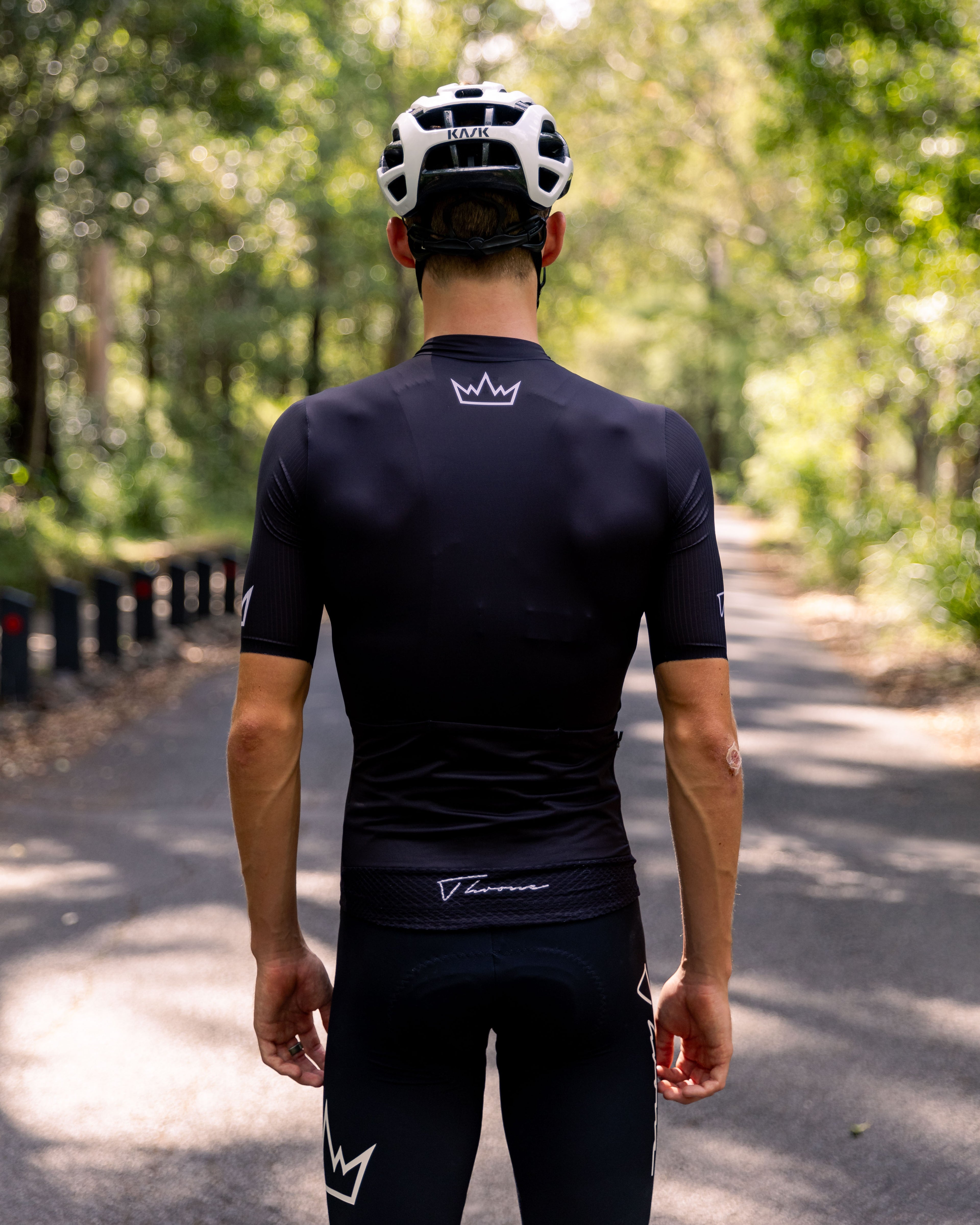 Man wearing THRONE Phase 1 black cycling jersey