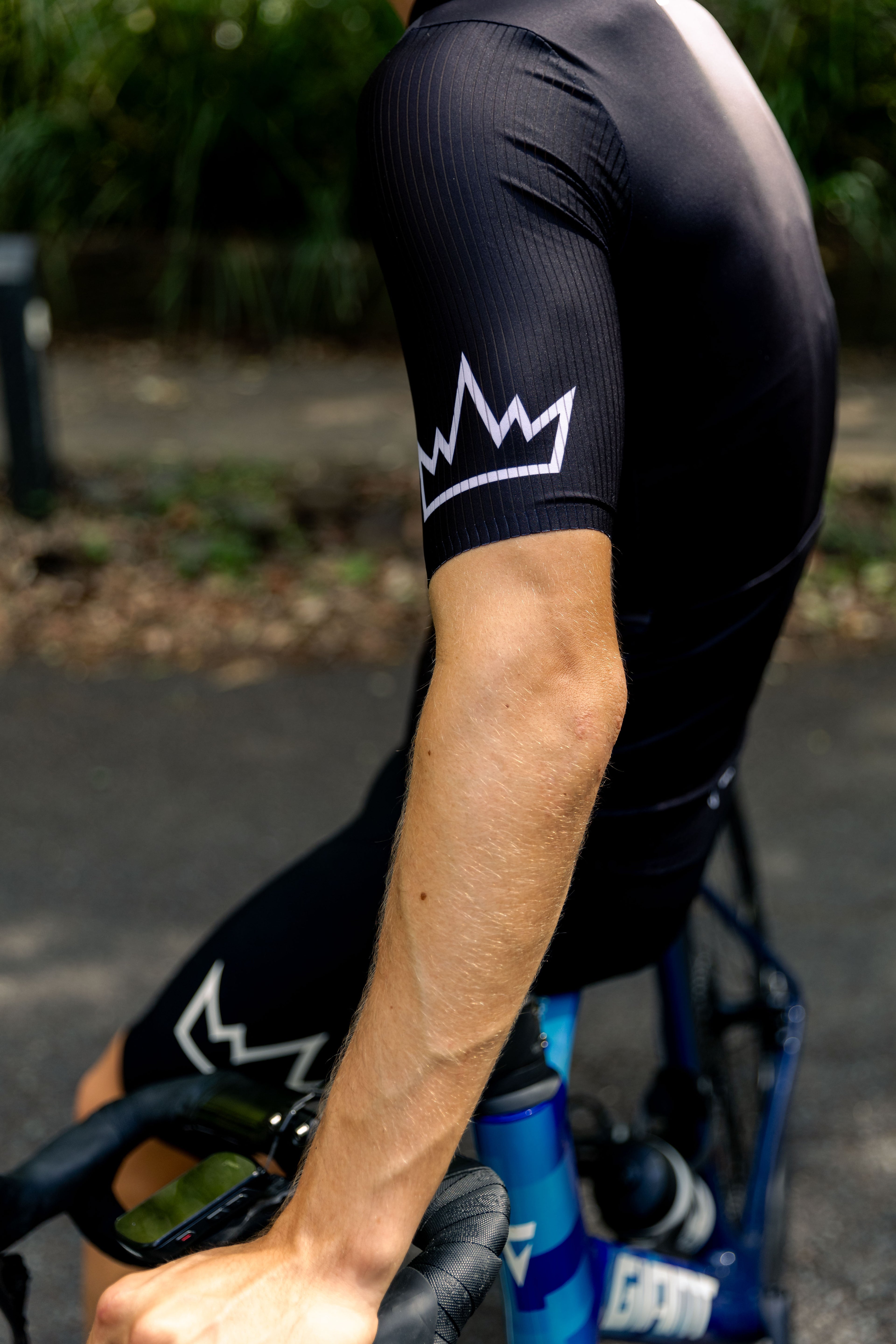 Man wearing THRONE Phase 1 black cycling jersey