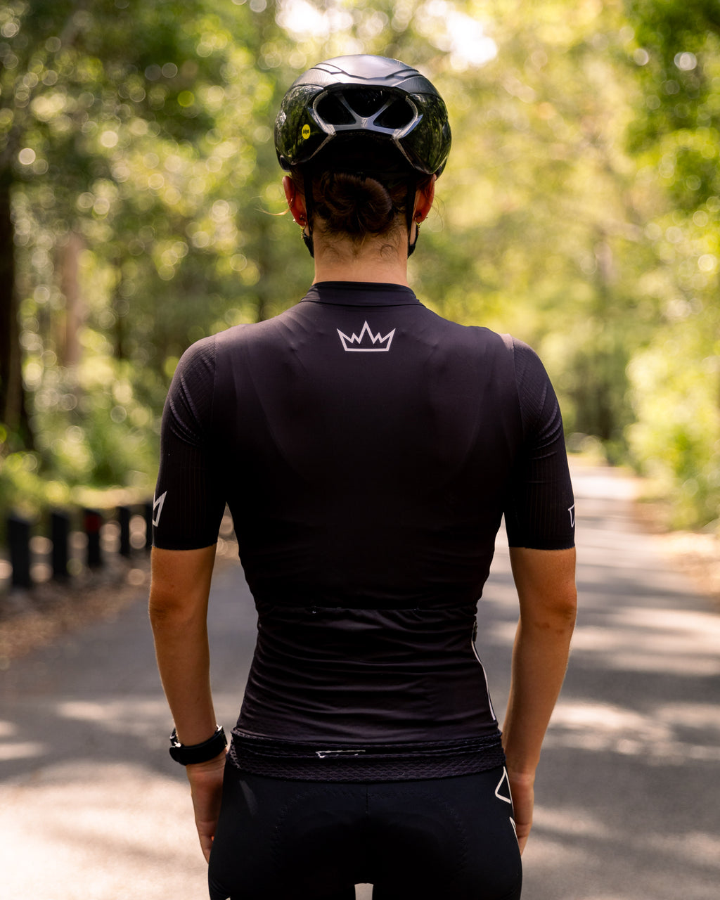 Woman wearing THRONE Phase 1 black cycling jersey