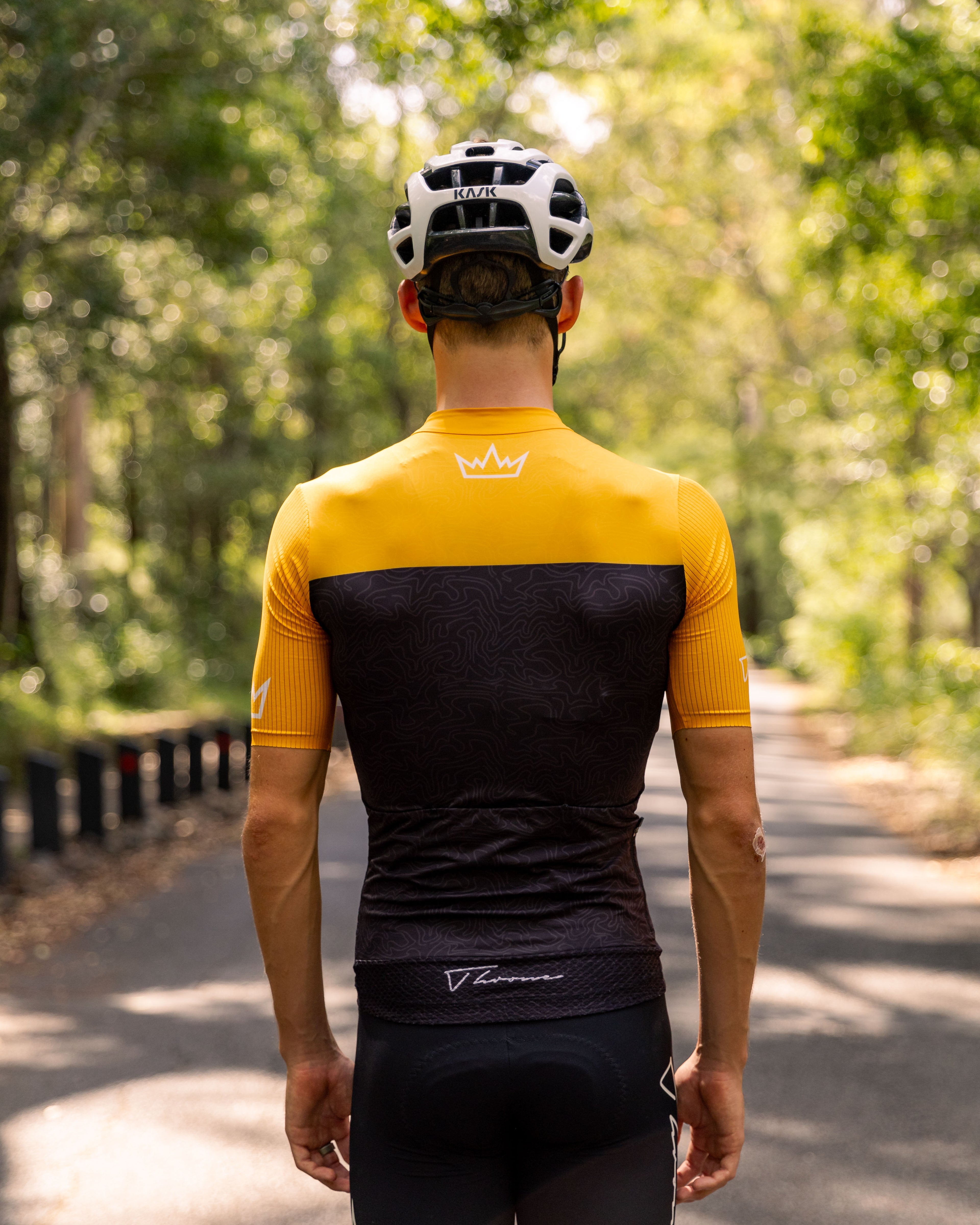 Man wearing THRONE Phase 1 Stacia orange cycling jersey