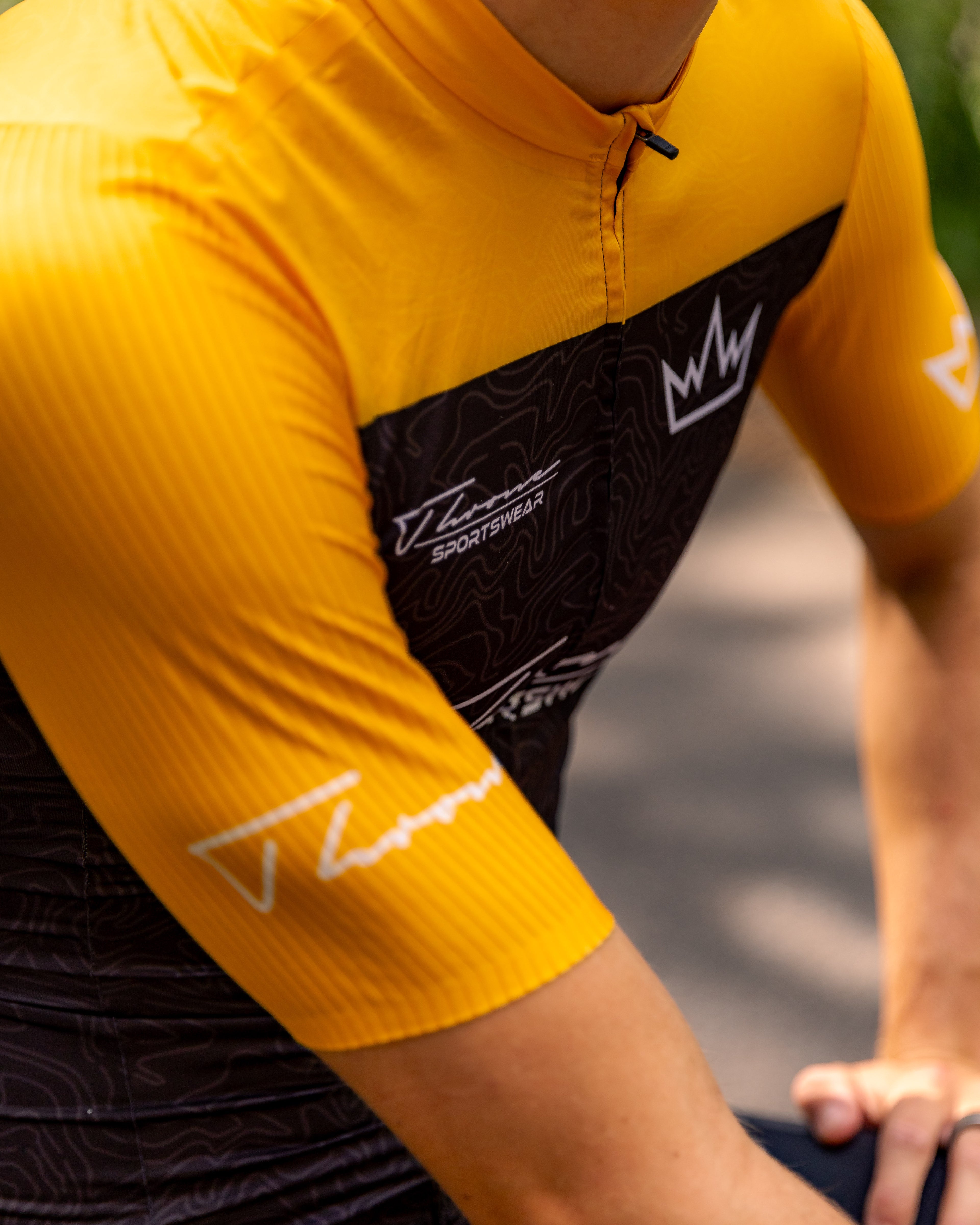 Man wearing THRONE Phase 1 Stacia orange cycling jersey