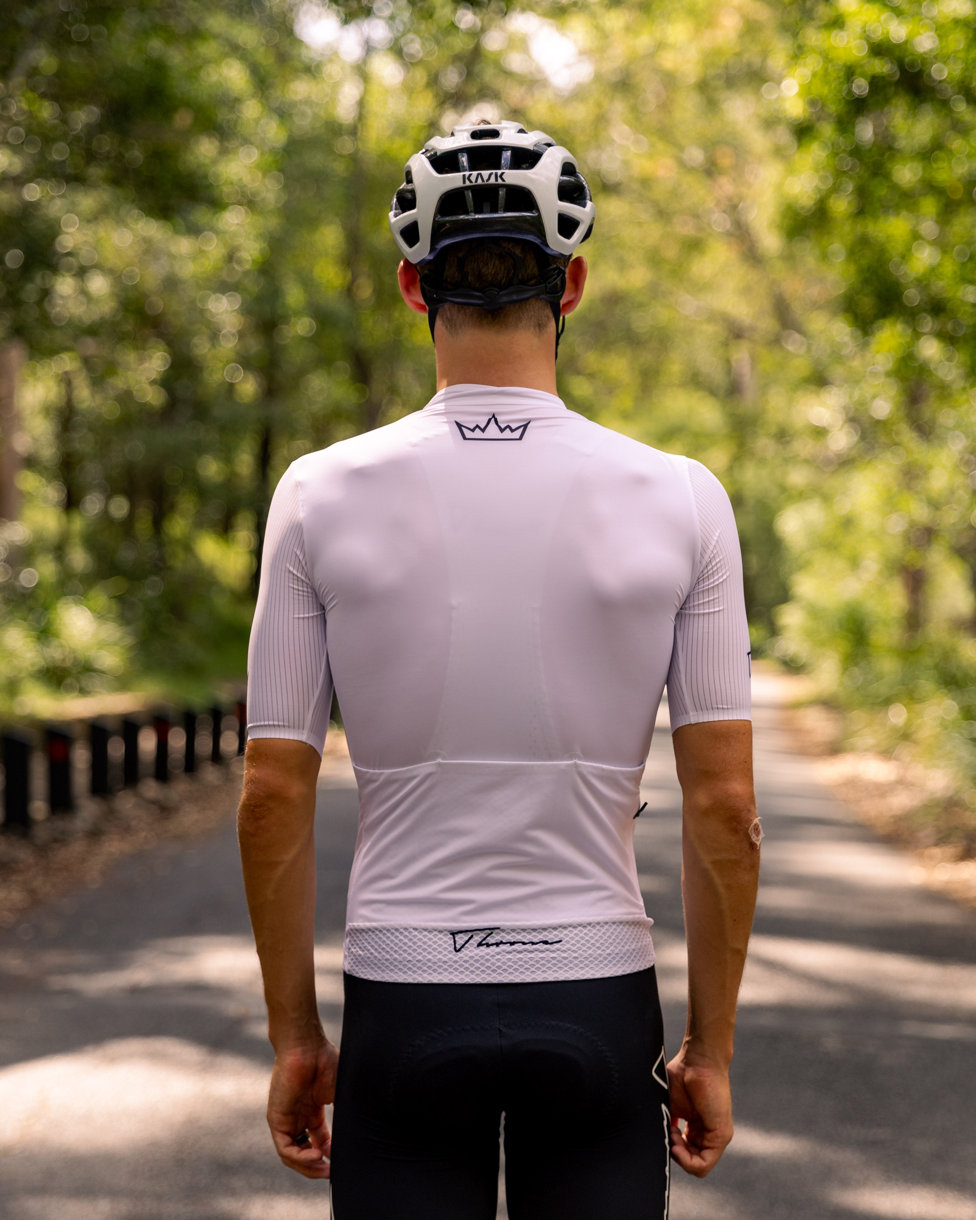 Man wearing THRONE Phase 1 white cycling jersey