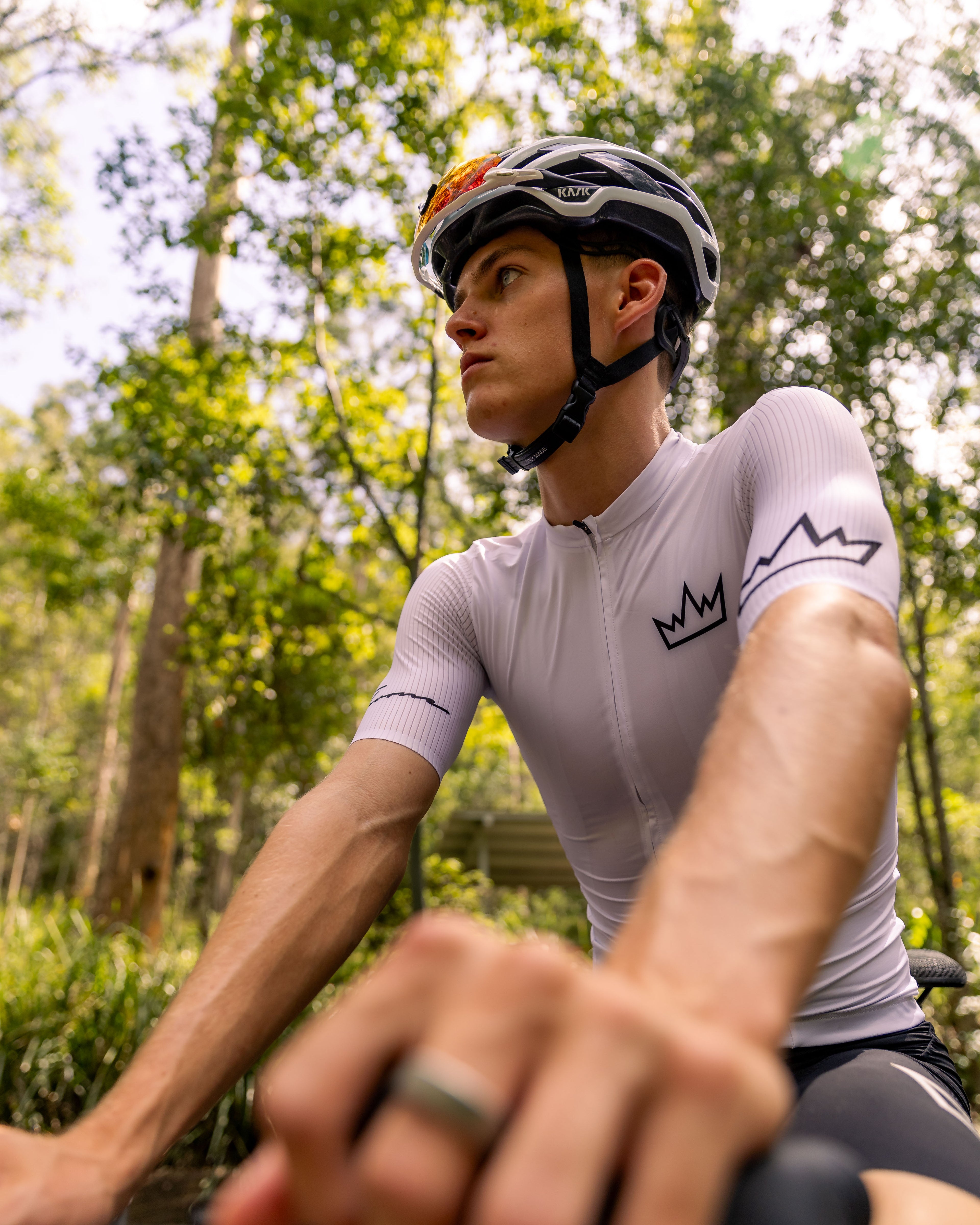 Man wearing THRONE Phase 1 white cycling jersey