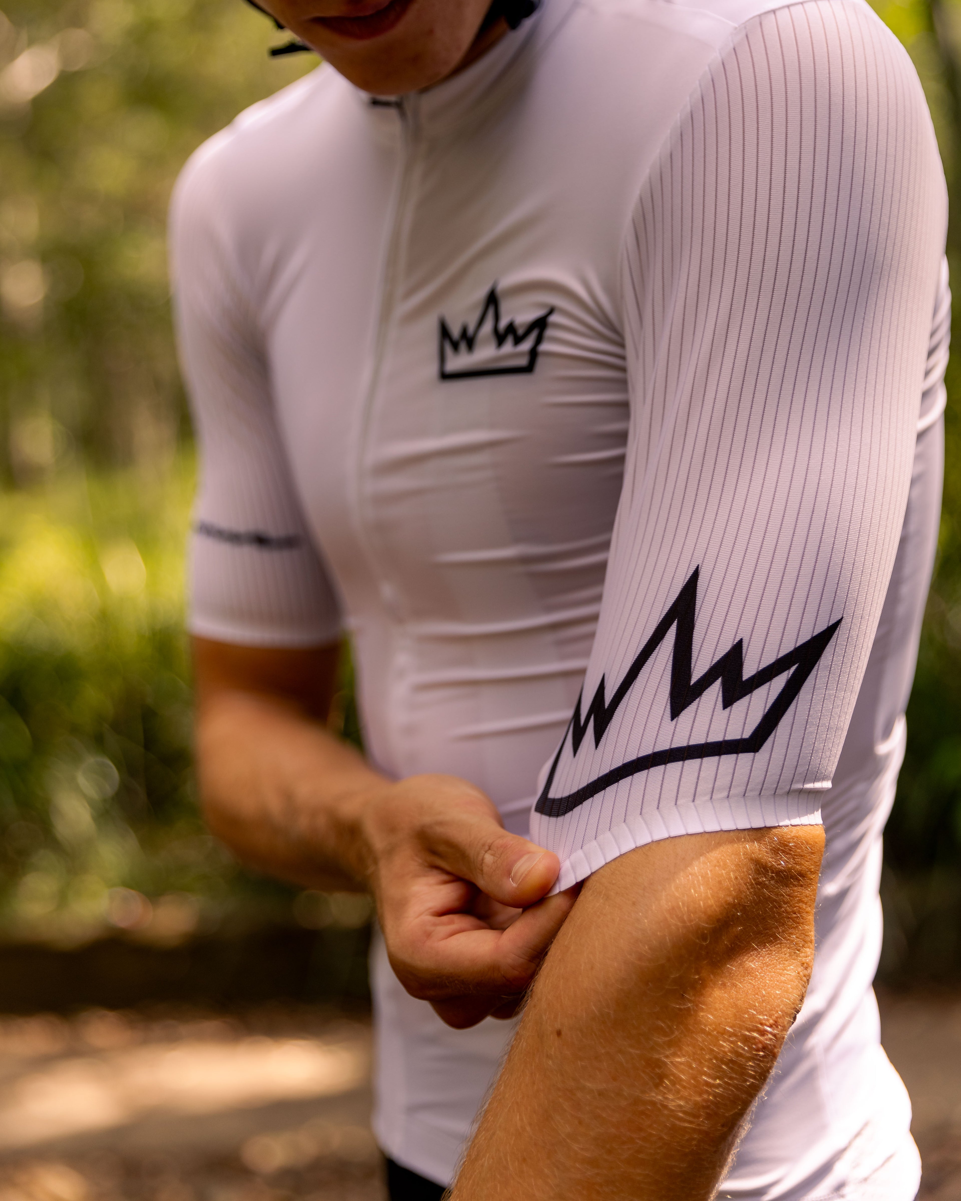 Man wearing THRONE Phase 1 white cycling jersey
