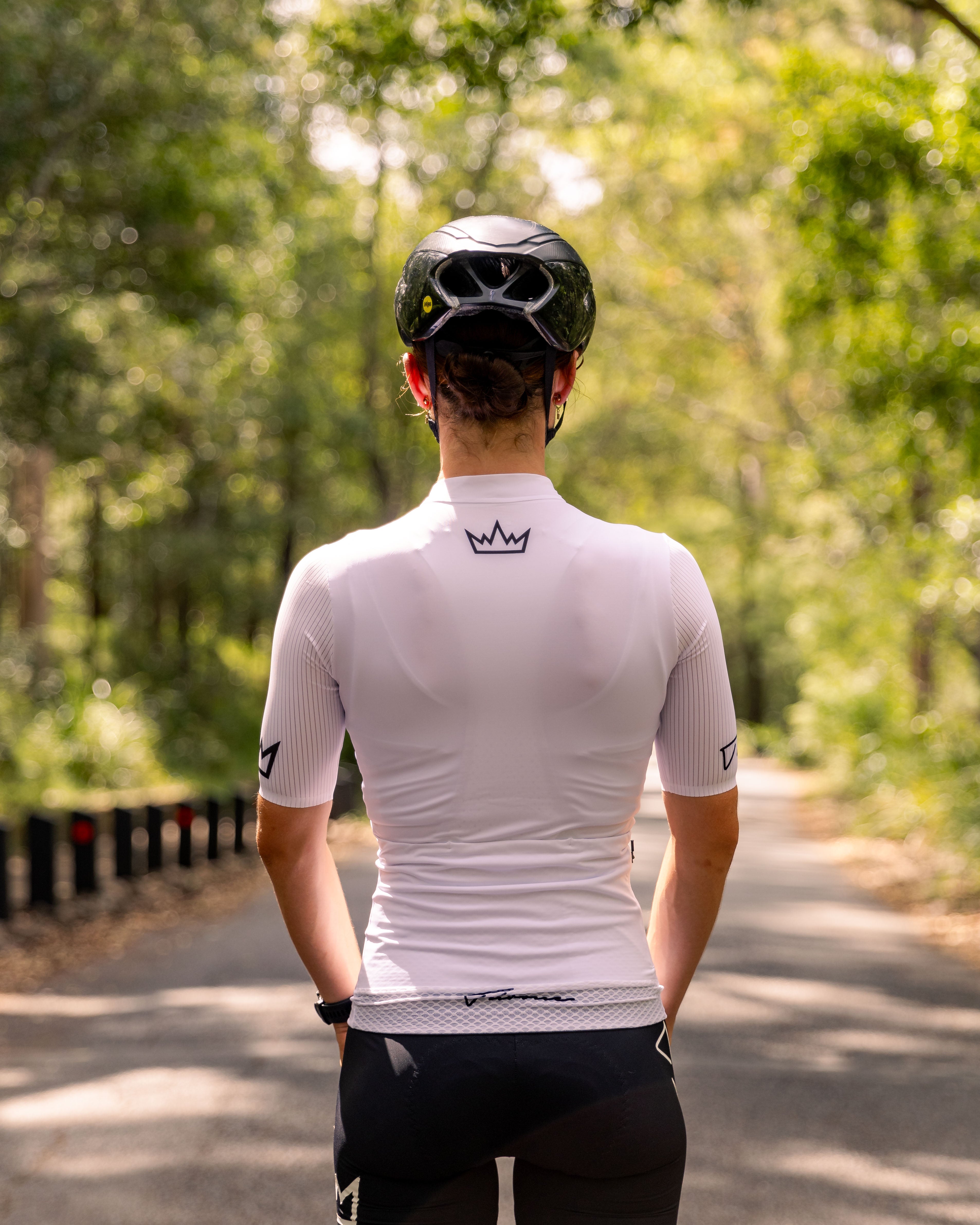 Woman wearing THRONE Phase 1 white cycling jersey
