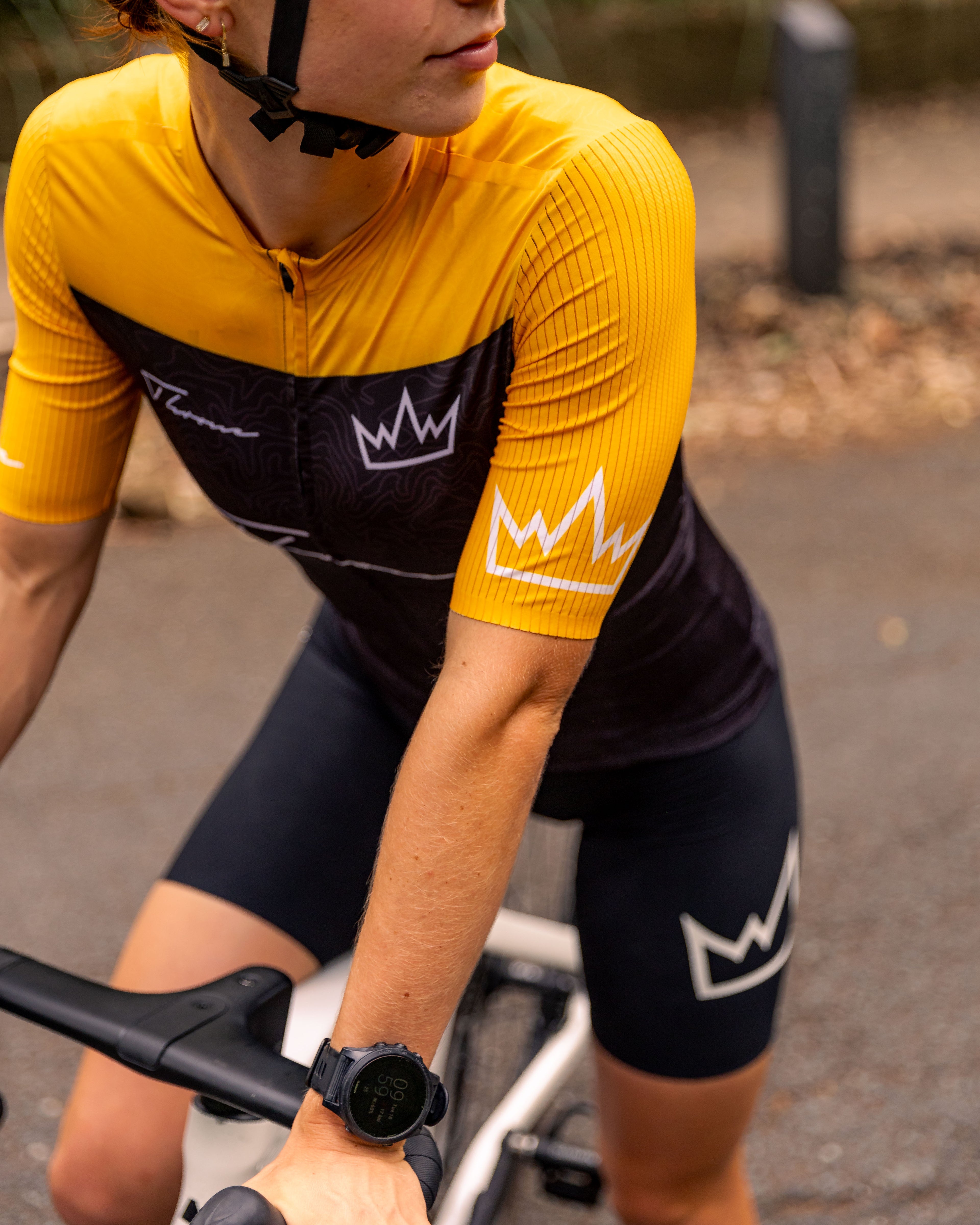 Woman wearing THRONE Phase 1 Stacia orange cycling jersey