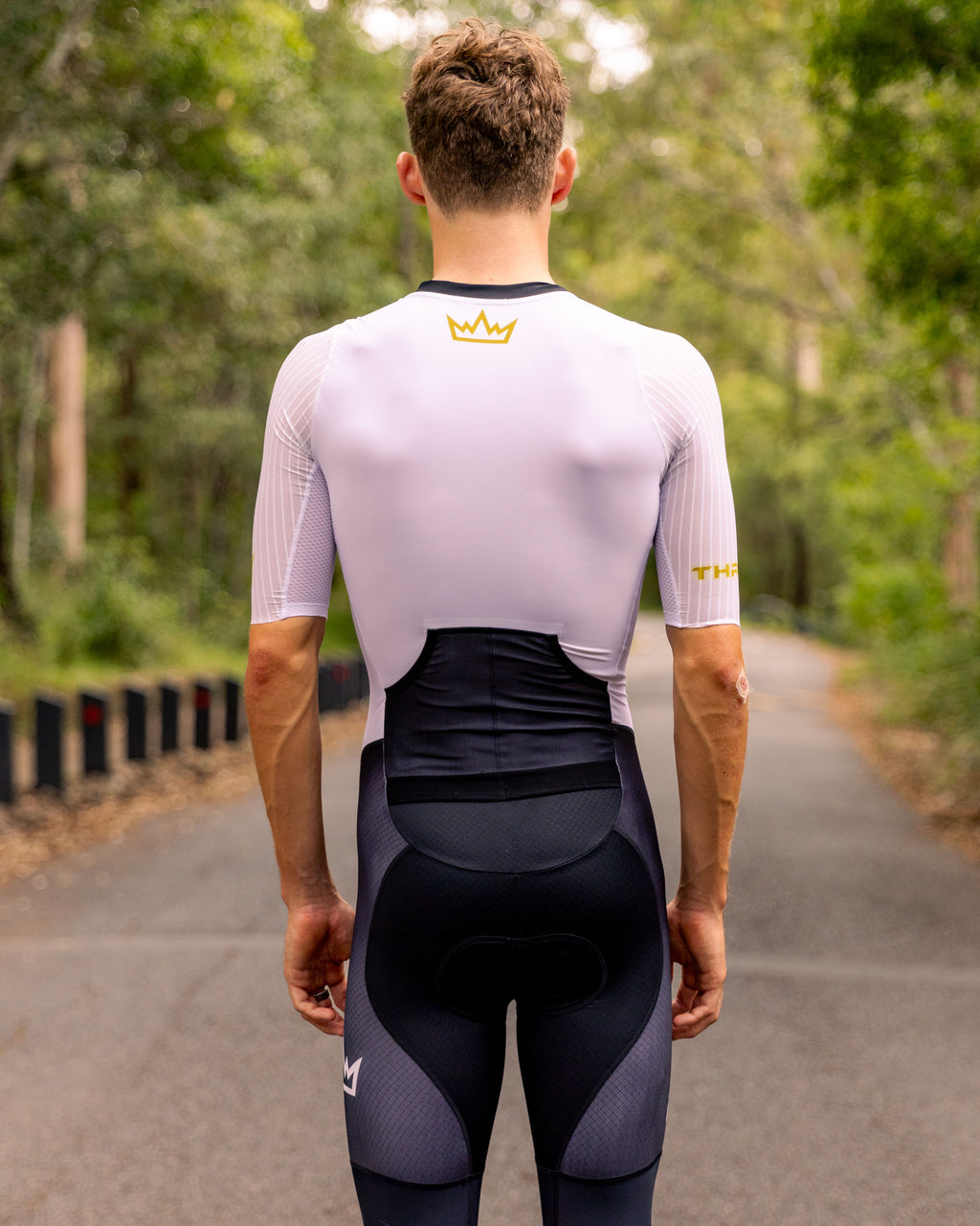 Man wearing THRONE VALOR white short-sleeve trisuit