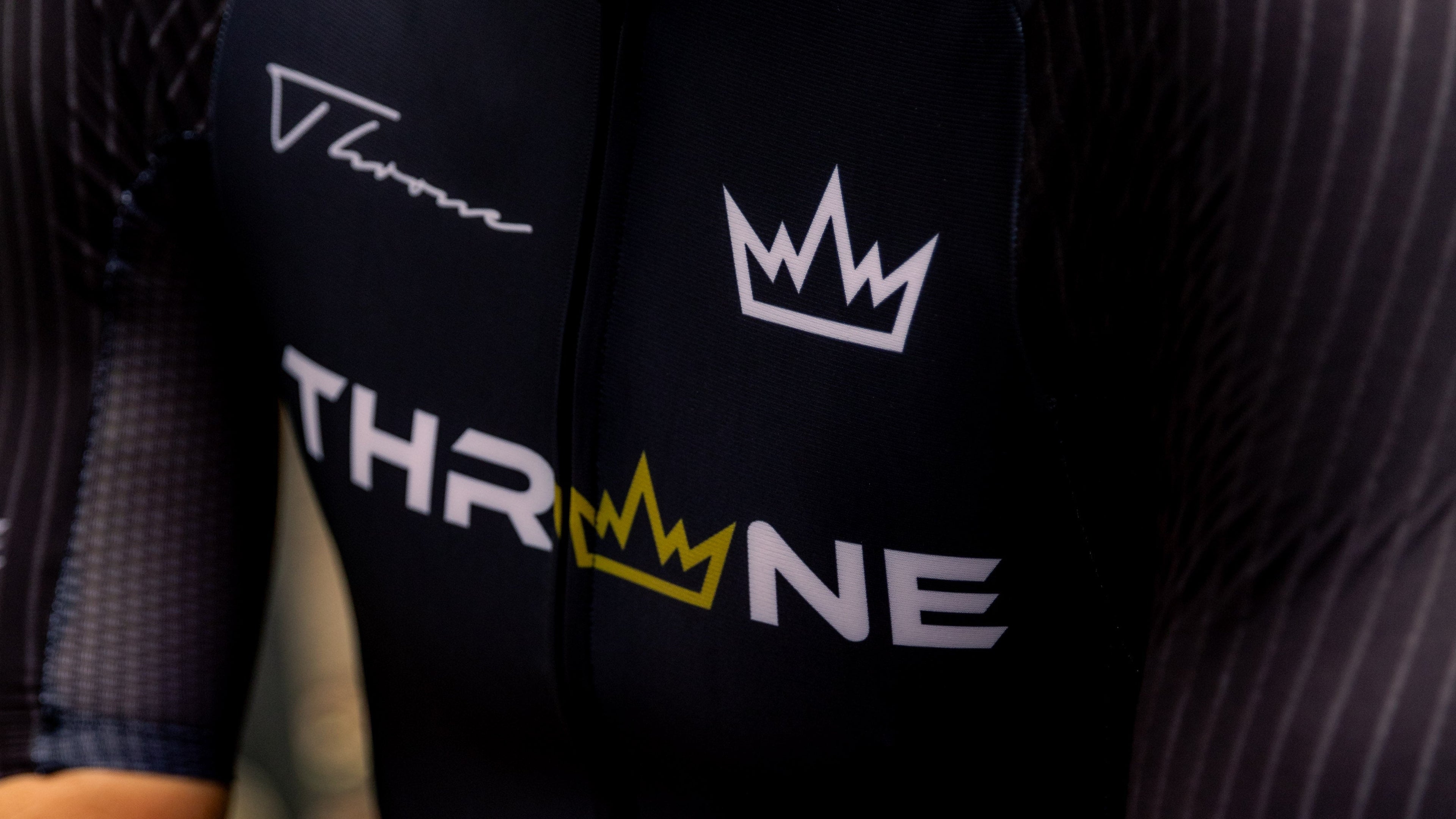 Man wearing THRONE VALOR black short-sleeve trisuit