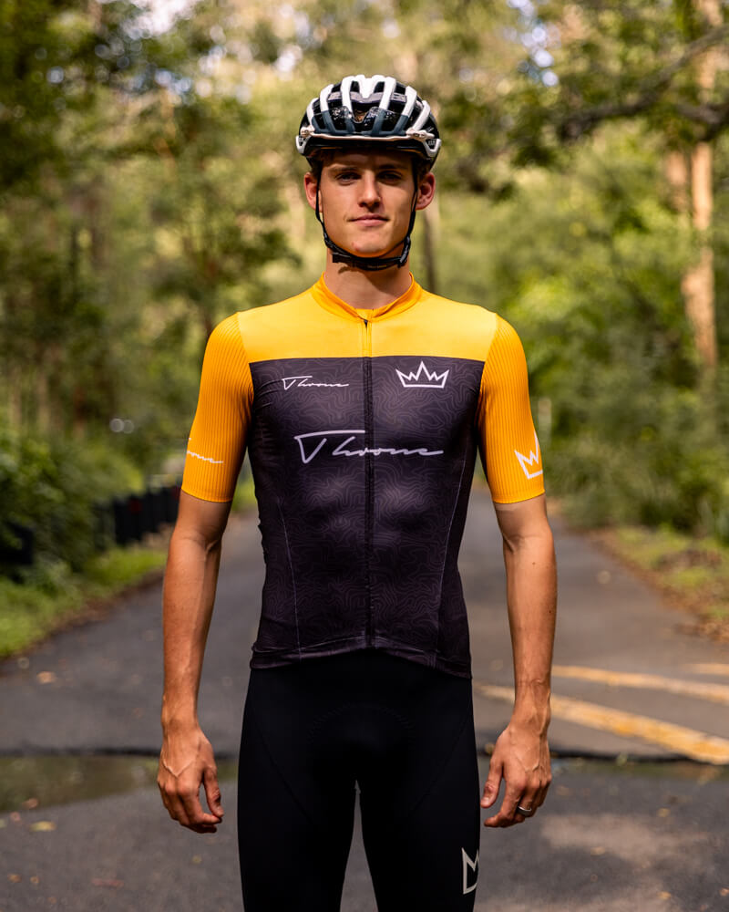 Man wearing THRONE Phase 1 Stacia orange cycling jersey