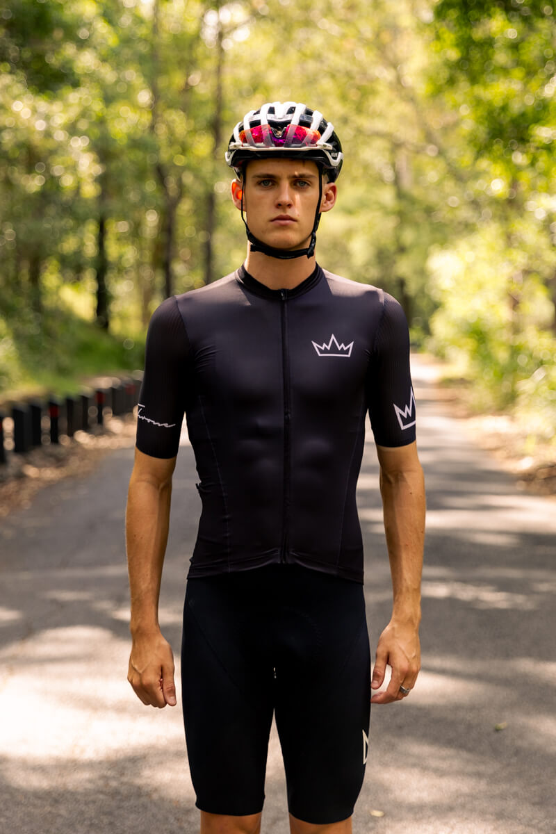 Man wearing THRONE Phase 1 black cycling jersey